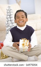 Portrait Of Boy With Christmas Present