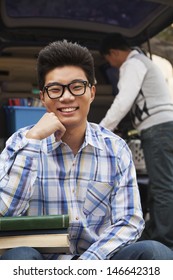 Portrait Of Boy With College Dorm Items In Back Of Car