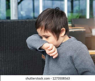 Portrait Boy Covering Nose With His Arm, Child Having Allergy And Sneezing While Playing Around,Kid Scratching Nose, Children Has Reflection Or Hay Fever From Dusty,Allergies And Asthma Issues In Kid