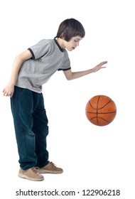 Portrait of a boy dribbling a basketball