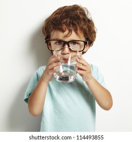 Portrait Of Boy Drinking Glass Of Water Isolated In White