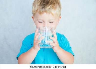 Portrait Of Boy Drinking Glass Of Water