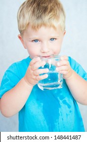 Portrait Of Boy Drinking Glass Of Water