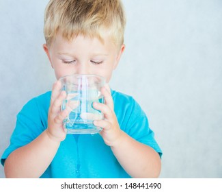 Portrait Of Boy Drinking Glass Of Water