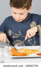 Portrait Of A Boy Eating Dinner Battered Fish And Chips