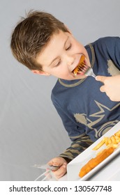 Portrait Of A Boy Eating Dinner Battered Fish And Chips