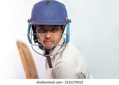 Portrait of boy getting ready to strike During a Cricket Game