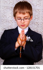 Portrait Of The Boy Going To The First Holy Communion Praying With A Rosary