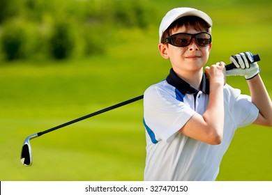Portrait of boy golfer in golf course at summer day