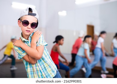 Portrait Of Boy Hip Hop Dancer Exercising With Friends At Dance Class