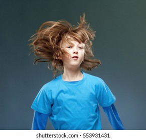 Portrait Of A Boy With His Hair Flying In The Air