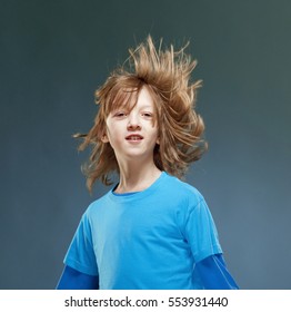 Portrait Of A Boy With His Hair Flying In The Air