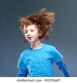 Portrait Of A Boy With His Hair Flying In The Air