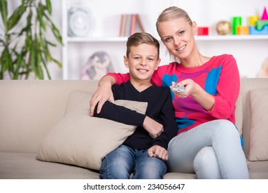 Portrait Of A Boy With His Mom Are Watching TV At Home.