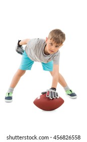 Portrait Of Boy Holding American Football Over White Background