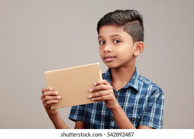 Portrait Of A Boy Holding A Parcel Box