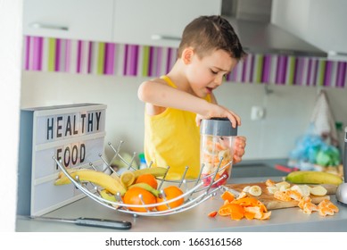 Portrait of a boy in the kitchen preparing his fruit smoothie