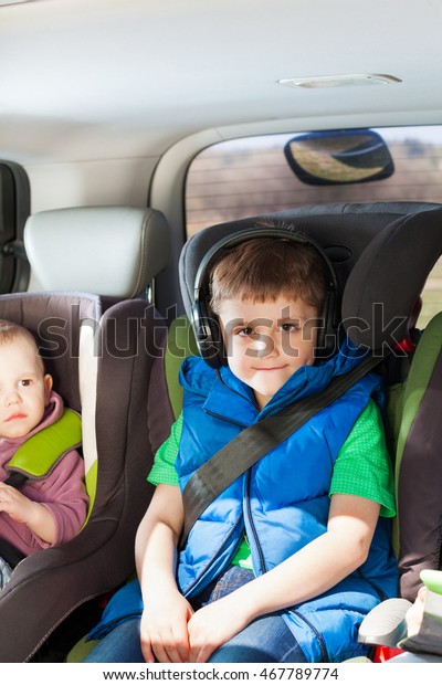 Portrait of boy\
listening to music in a car\
trip