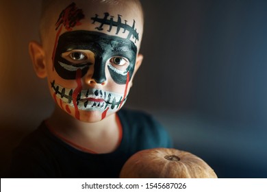 Portrait of a boy on Halloween holiday. Painted face of a female child like a forcelet or goiter, concept of horror. Halloween death day