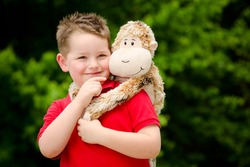 Portrait Of Boy Playing With His Stuffed Animal Pet