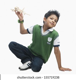 Portrait Of Boy Playing With A Toy Airplane