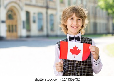 Portrait Boy. Schoolboy With The Flag Of Canada. Education In A Junior School In Canada.