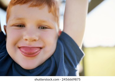 Portrait, boy and smile in park, monkey bars and happy with playing, outdoor and adventure, Child, playground and jungle gym or tongue out, obstacle course and active on vacation, holiday and games