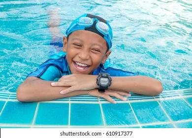 Portrait Of A Boy Smiling In Public Swimming Pool
