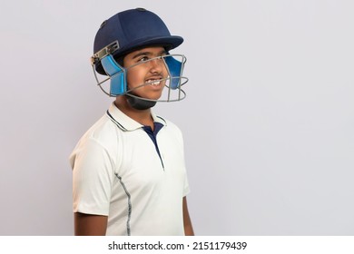 Portrait of boy wearing cricket Helmet looking elsewhere