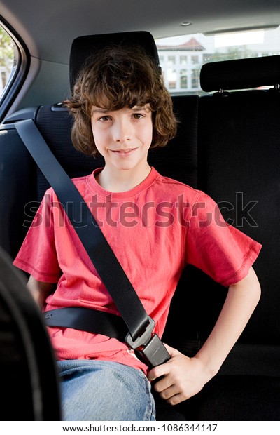 Portrait of a boy wearing a\
seatbelt