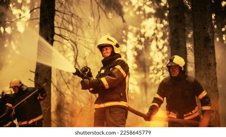 Portrait of a Brave Professional Female Firefighter Using a Firehose to Fight a Raging Dangerous Wildfire. Experienced Team Skillfully Manage the High-Pressure Water and Stay Protected and Safe. - Shutterstock ID 2258645779