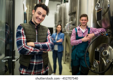 Portrait of brewers posing at brewery factory - Powered by Shutterstock