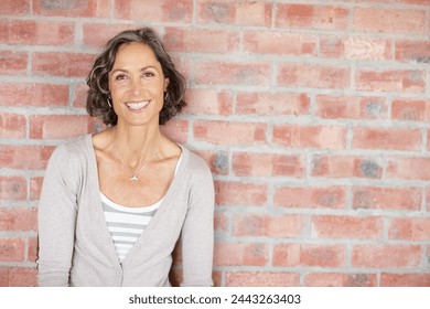 Portrait, brick wall or woman in small business, fashion or design office as creative career. Mature, businesswoman or smile in pride at professional style agency or trendy boutique in New York - Powered by Shutterstock