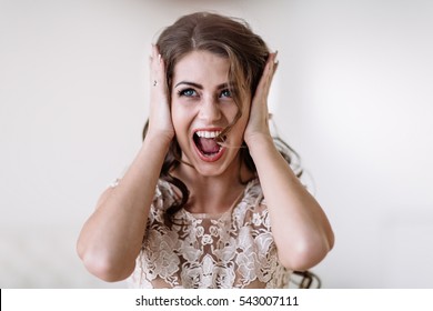 Portrait Of The Bride Shouts Loudly Covering His Ears With His Hands, Furious. Natural Light. Eyes Open