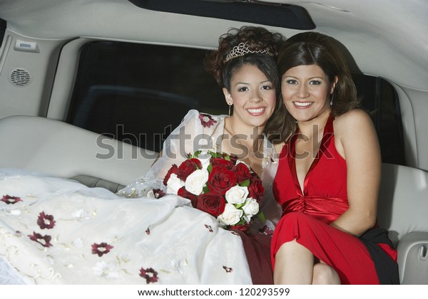 Portrait of a  bride sitting with female friend\
sitting in car