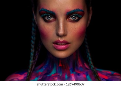 Portrait of the bright beautiful woman with art colorful make-up