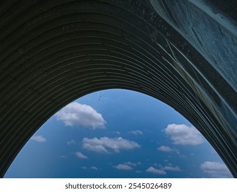 Portrait of a bright blue cloudy sky from under a highway bridge - Powered by Shutterstock