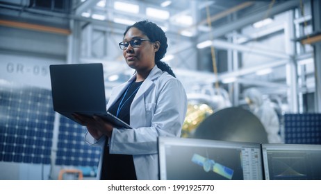 Portrait Of Brilliant Female Engineer Confident And Focused Thinking, Working At Aerospace Satellite Manufacturing Facility. Top World Scientist Doing Science And Technology Research In Space Program