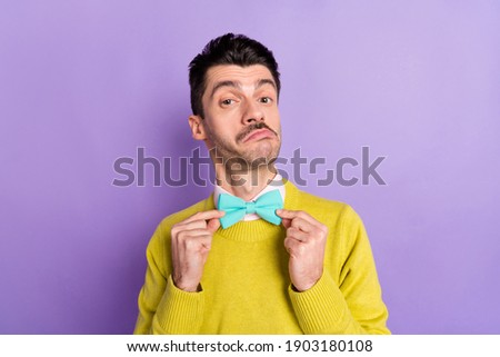 Portrait of brunet funny optimistic guy touch tie wear yellow sweater isolated on pastel lilac color background