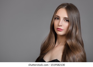 Portrait of a brunette with curly hair. Hair shine - Shutterstock ID 1519582130