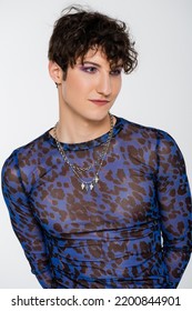 Portrait Of Brunette Nonbinary Model In Stylish Long Sleeve Shirt And Silver Necklaces Isolated On Grey