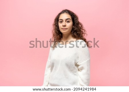 Portrait of brunette woman with curls on pink background