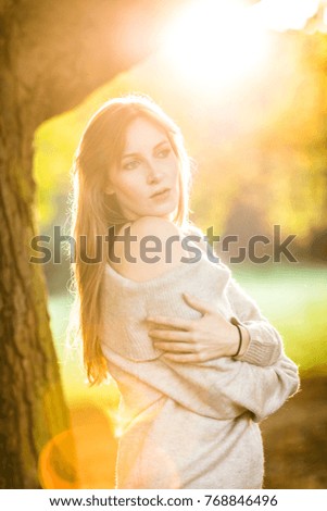 portrait of a brunette young independent happy woman in autumn park happy thoughtful spring autumn mood at golden hour