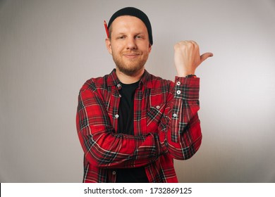 Portrait Of A Brutal Successful Builder, On A Light Background. Average Plan Of A Man In A Plaid Work Shirt. .Isolation, Copy Space Next To A Person.