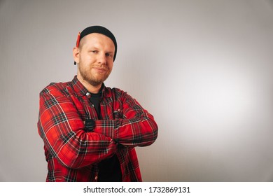 Portrait Of A Brutal Successful Builder, On A Light Background. Average Plan Of A Man In A Plaid Work Shirt.