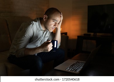 Portrait Of A Burnout Man Working Late At Night From Home And Drinking Coffee To Stay Awake