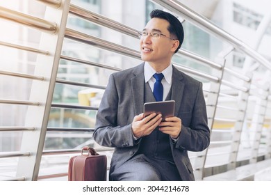 Portrait Business Asian Man , Senior Visionary Executives Leader With Business Vision On Business District , Tablet Phone Computer In Hand - Lifestyle Business People Concept