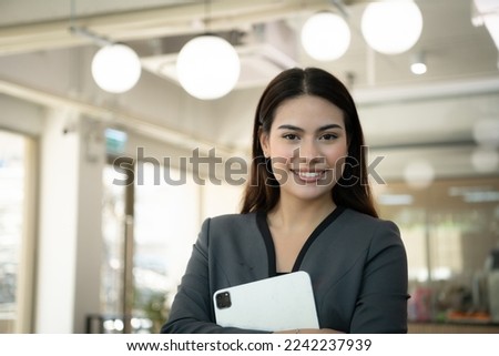 Portrait of Business female rookie in the new entrepreneurial with a tablet as a tool to help in the work