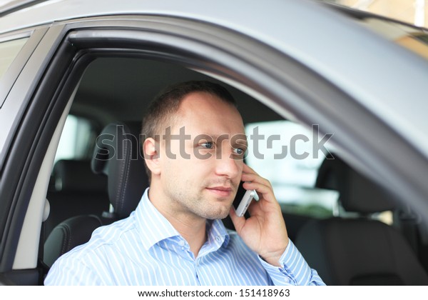 Portrait of business man\
inside the car