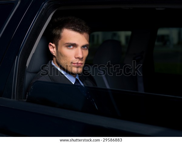Portrait of business man\
inside the car